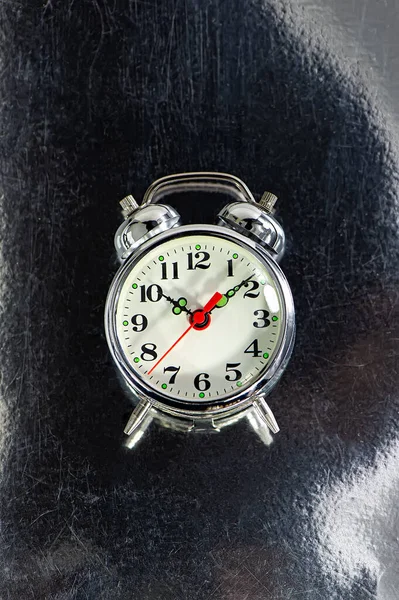 old mechanical alarm clock lies on a scratched metal surface. Web banner. Cover.