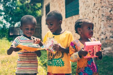 African kids getting gifts from tourists, Tanzania