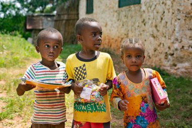 African kids getting gifts from Russian tourists, Tanzania