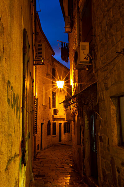 Empty narrow street in old city at the night