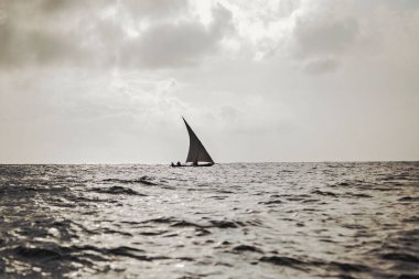 WATAMU, KENYA - January 2021: African fishermen catching fish from the boat in Watamu bay, Kenya