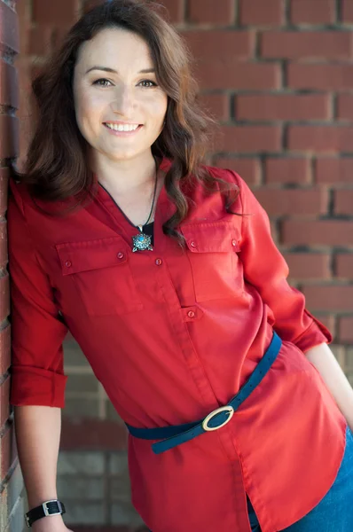 Beautiful young brunette near red brick wall - 2 — Stock Photo, Image