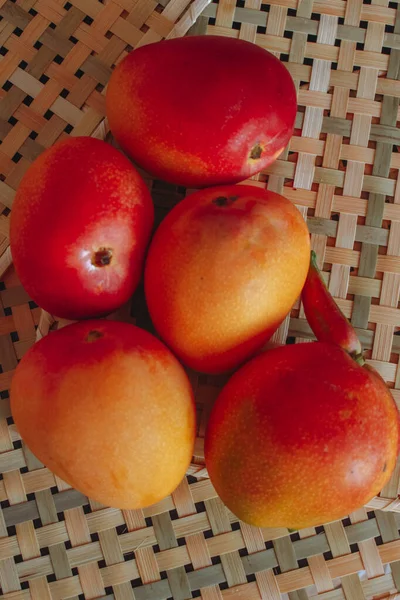 Ripe red mangoes on the table