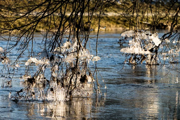 Light reflected through icicles at a river in winter time, frankfurt, hesse, germany