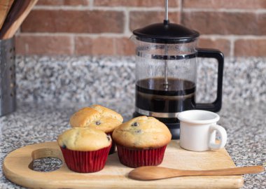 Mutfak tahtasına sarılı taze pişmiş yaban mersinli çörekler.