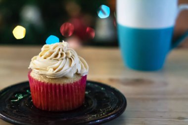 Buzlu kek, ahşap bir masa ve arka planda biraz sigara.