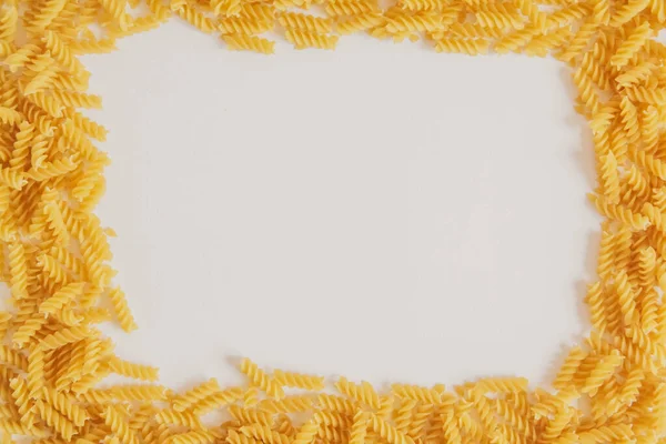 Spiral Pasta White Background Forming Frame Top View Copy Empty — Stock Photo, Image