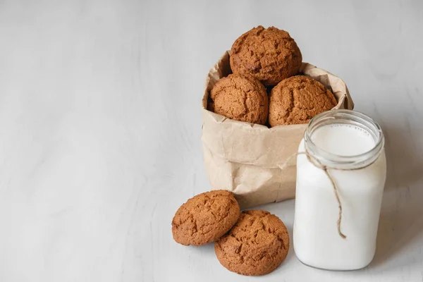 Milch Glas Und Haferflockenkekse Einer Papiertüte Auf Weißem Tischhintergrund Kopieren — Stockfoto