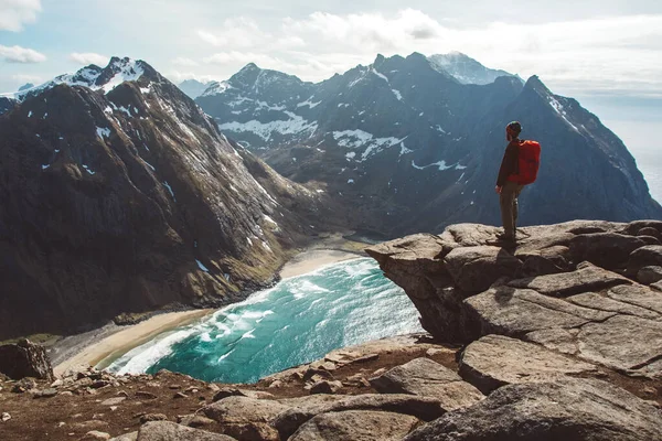 Man stand on cliff edge alone enjoying aerial view backpacking lifestyle travel adventure outdoor vacations.