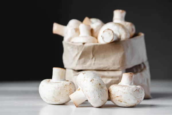 Champignons Papiertüten Auf Einem Weißen Holztisch Vor Dunklem Hintergrund Platz — Stockfoto