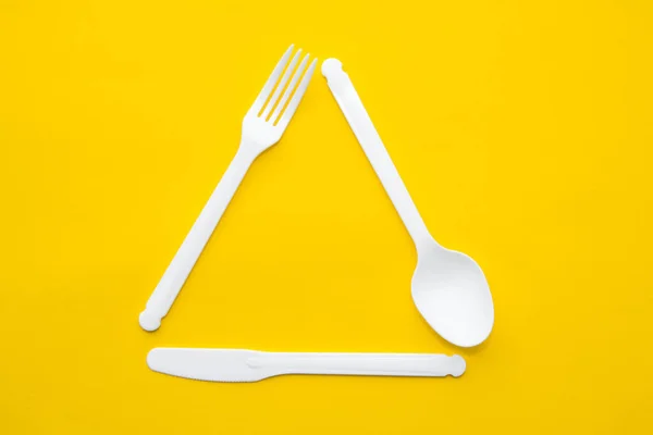 Plastic White Fork Knife Spoon Form Triangle Yellow Background Cooking — Stock Photo, Image