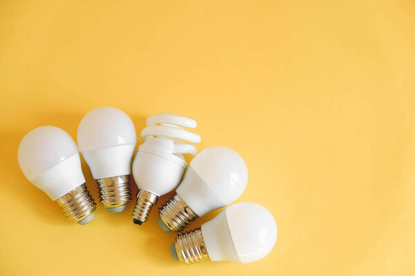 LED light bulbs on yellow background. Top view. Copy, empty space for text.