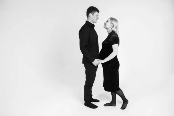 Pregnant Woman Her Husband Holding Hands Black Clothes White Background — Stock Photo, Image