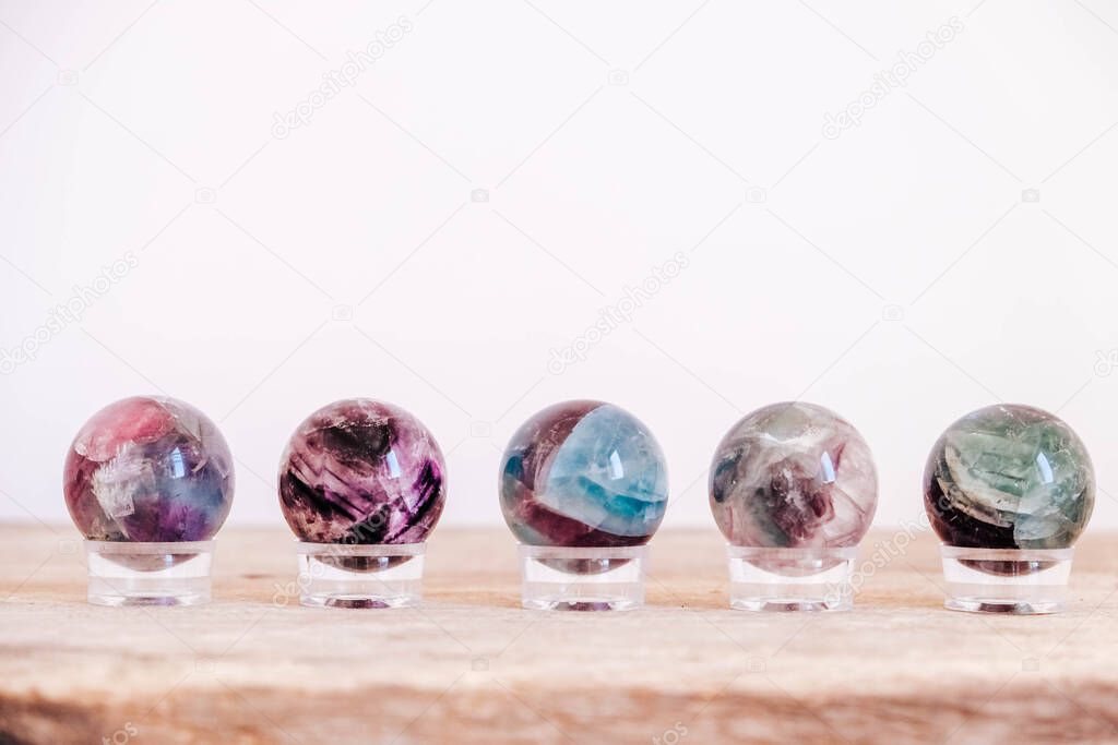 Crystals in the form of balls on a wooden table. Copy, empty space for text.