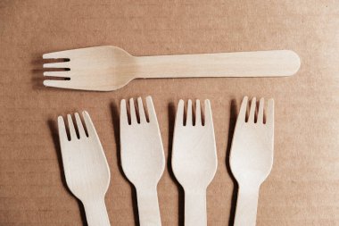 Tahta çatallar karton arka planda. Çevre dostu tek kullanımlık sofra takımı. Üst Manzara. Kopyala, metin için boşluk.