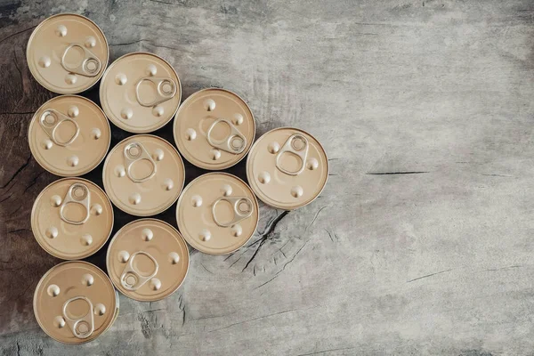 Metal closed canned food on a wooden background. Top view. Copy, empty space for text. — Stock Image Metal Closed Canned Food Wooden Background Top View Copy Empty Stock Photo