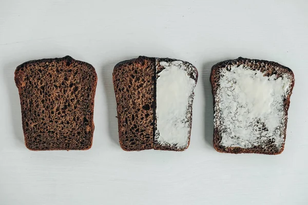 Κομμένο Από Καφέ Ψωμί Βούτυρο Λευκό Ξύλινο Φόντο Στο Πάνω — Φωτογραφία Αρχείου