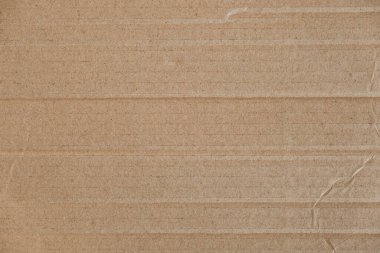 Buruşmuş karton yüzey dokusu arka planı. Kusursuz buruşuk kahverengi kağıt kaplama. Üst Manzara. Kopyala, metin için boşluk.