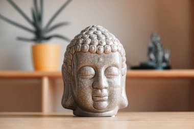 Ahşap bir rafta bir Buda 'nın seramik heykeli. Kopyala, metin için boşluk.