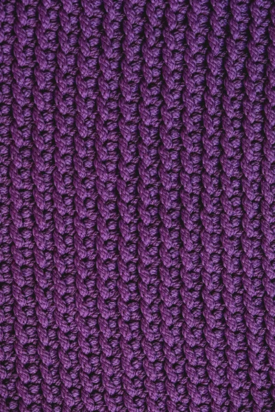 Violet knitted fabric texture background. Top view. Copy, empty space for text.