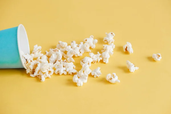 Popcorn Modrém Papírovém Kelímku Roztroušený Žlutém Pozadí Minimalistický Koncept Kopírovat — Stock fotografie