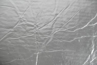 Arka plan dokusu görüntüsü olarak alüminyum gümüş folyo. Üst Manzara. Kopyala, metin için boşluk.