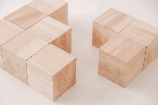 Stack wooden blocks from natural wood on a white background. Copy, empty space for text.