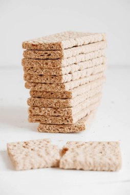 Beyaz ahşap arka planda istiflenmiş çavdar ekmeği. Kopyala, metin için boşluk.
