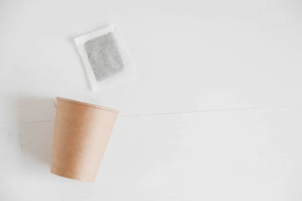 白い背景に紙コップと正方形の乾燥ティーバッグ 最上階だ テキストのコピー 空のスペース — ストック写真