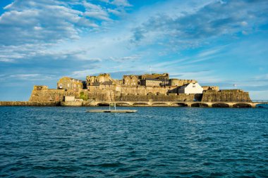 Castle Cornet has guarded Saint Peter Port and harbor for 800 years. Saint Peter Port - capital of Guernsey - British Crown dependency in English Channel off the coast of Normandy. clipart