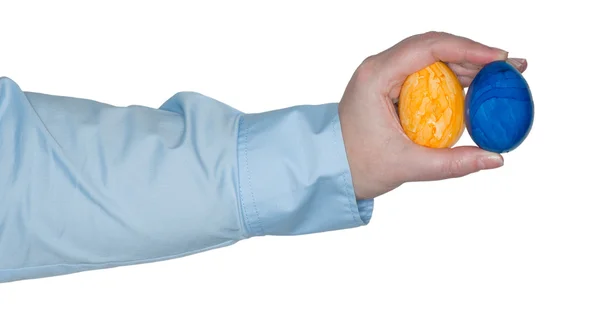 Female arm holding two colored egg in her hand — Stock Photo, Image