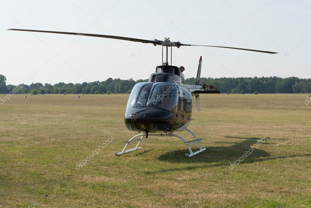 Helicopter in green field