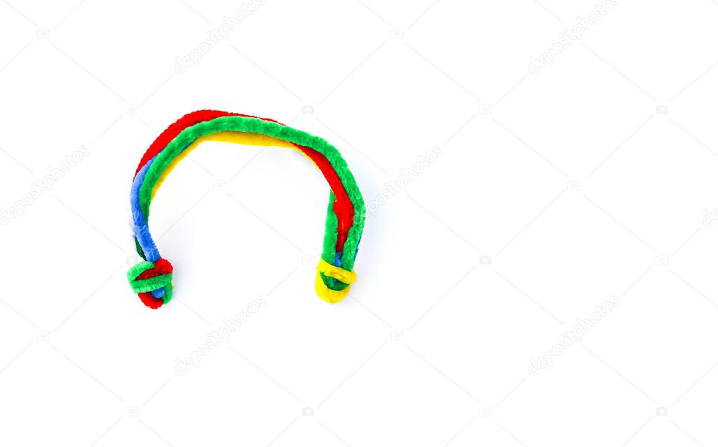 Soft craft wire in the shape of the rainbow on white background