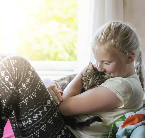 Teenager girl with cat at home