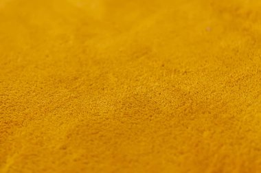 Sıcak, yumuşak, sarı tekstil yüzeyi. Yaklaş. Sentetik kumaş dokusu.