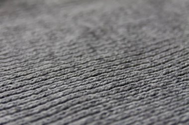 Gri tekstilin yünlü örgü yüzeyi. Doğal tekstil geçmişi. Ağır örgü deseni.