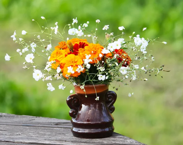 Blumenstrauß auf Holztisch — Stockfoto