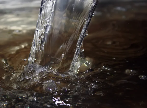 Pouring water  in metal bowl — Stock Photo, Image