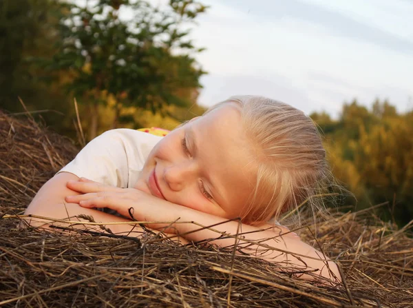 Girl sleeping on a hay — Stock Photo, Image