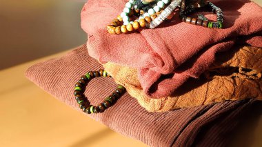 Konforlu kumaş yüzeyi olan ahşap kontrasttan yapılmış canlı bilezikler. Sahne yaratıcılığı, rahatlığı ve dünyevi tarzı yansıtıyor..