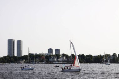 Riga, Latvia - June 30, 2024: Colorful sails glide over blue sea waves.