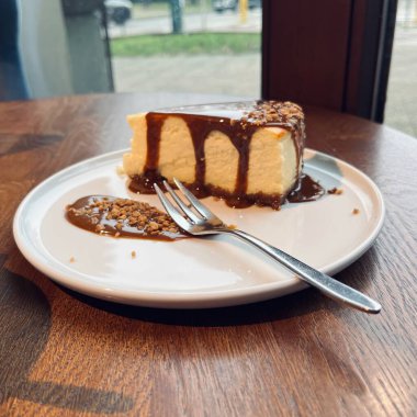 İçi kremalı geleneksel cheesecake tatlıları, bisküvi tabanı ve akıcı tuzlu karamel sosu, tatlı yemek geçmişi veya restoran sunumu için ideal..