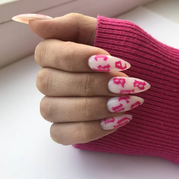 Hands of a woman with white manicure and design on nails.Manicure beauty salon concept. Empty place for text or logo.