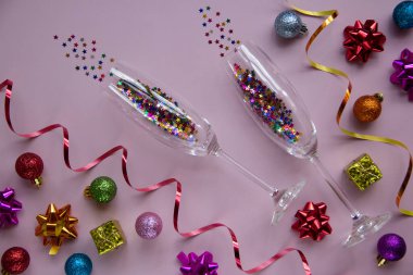 Gözlüklerin yaratıcı Noel düzeni ve pembe arka planda yeni yıl süslemeleri. Tebrik kartı. Kış tatili, Noel zamanı konsepti. Düz yatıyordu.