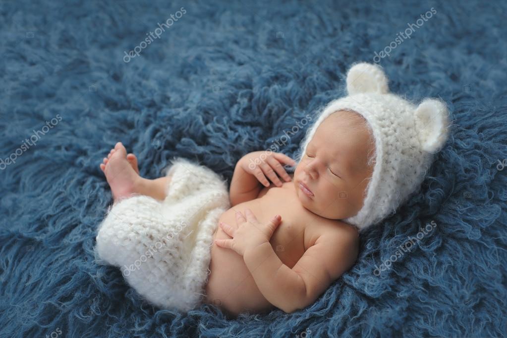 Newborn Baby Boy Wearing a White Bear Costume Stock Photo by