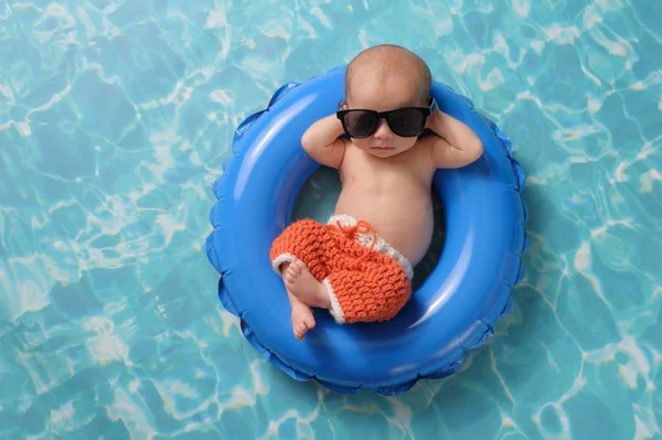 Newborn Baby Boy Floating on an Inflatable Swim Ring — Stock Photo, Image