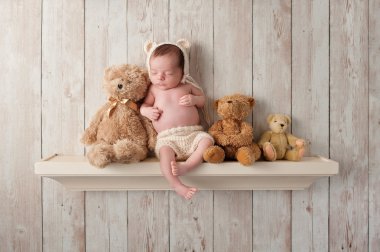 Newborn Baby Boy on a Shelf with Teddy Bears