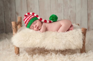 Newborn Baby Boy Wearing a Christmas Elf Hat clipart