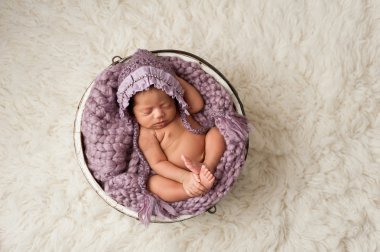 Newborn Girl Sleeping in a Wooden Bucket