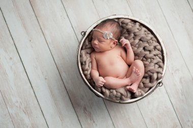 Newborn Girl Sleeping in Wooden Bowl clipart